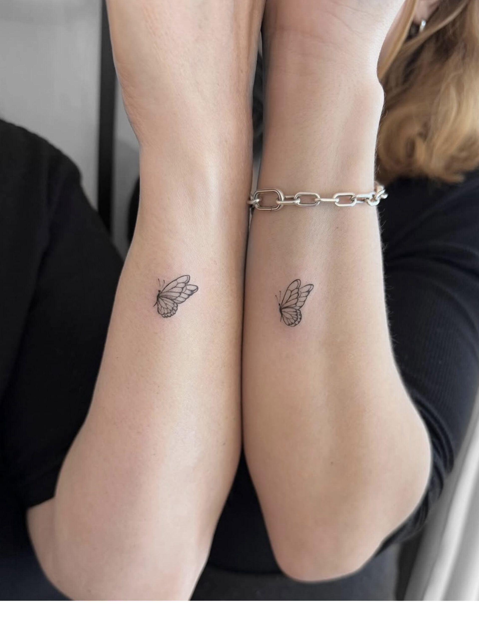 Zwei kleine Fine Line Schmetterling-Tattoos am Handgelenk in Berlin-Schöneberg